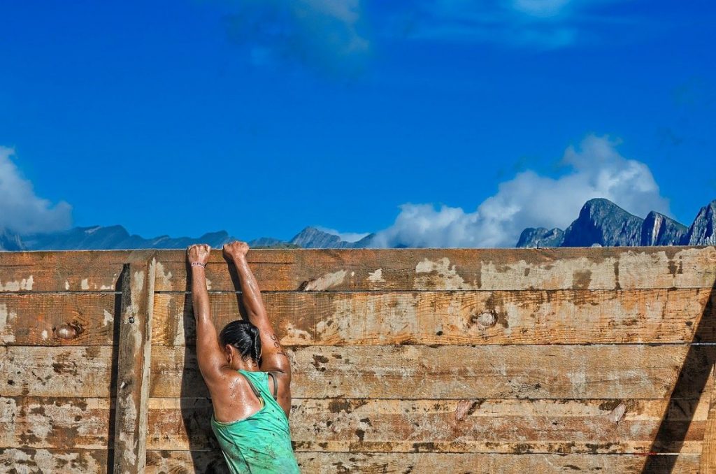Girl climbing a wall.