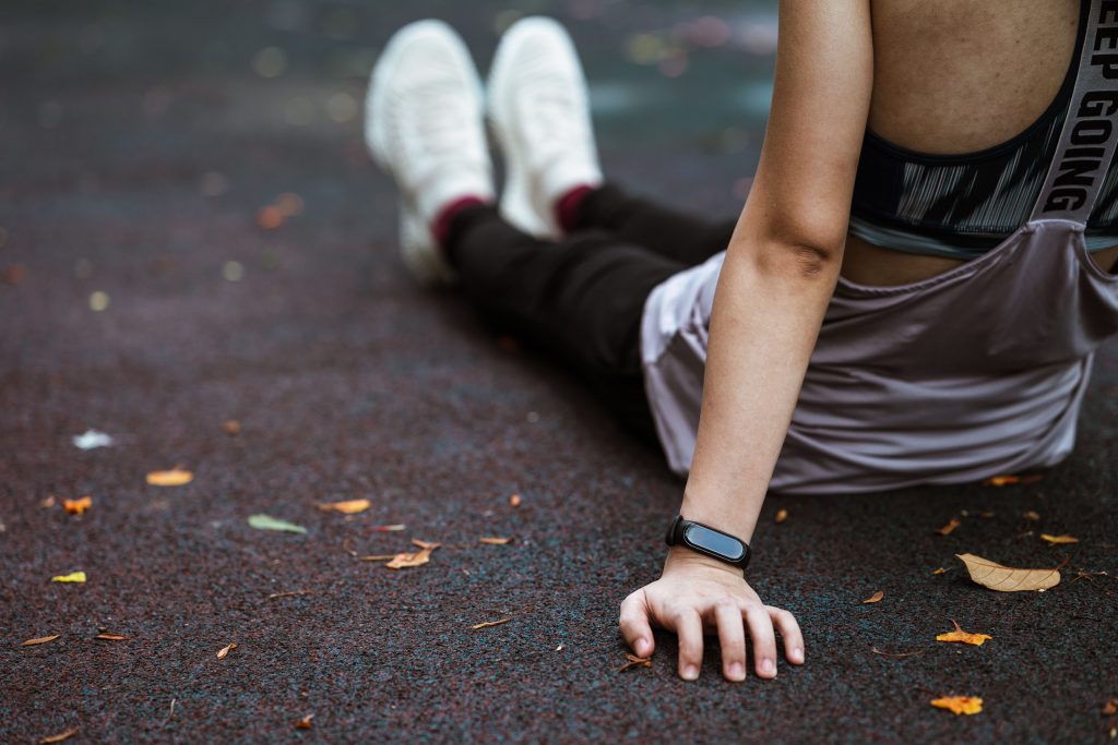 Girl sitting on the floor after exercise .