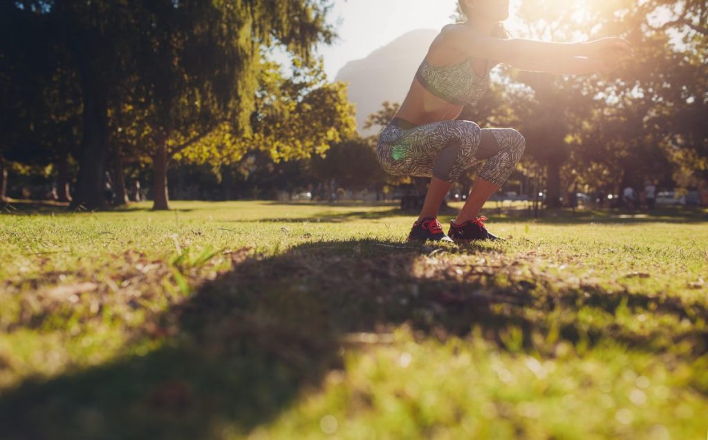 Girl exercising outside safely.